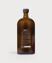 Rückseite der braunen Glasflasche H2O Fit von ProEnergetic mit weißer Produktbeschreibung und schwarzem Schraubverschluss.