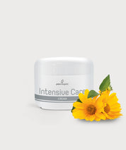 Tiegel Intensive Care Cream mit gelben Blüten und grünen Blättern auf hellem Hintergrund.