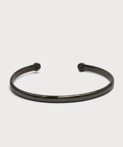 Hematite-colored Vitality Bangle with an open design on a light background